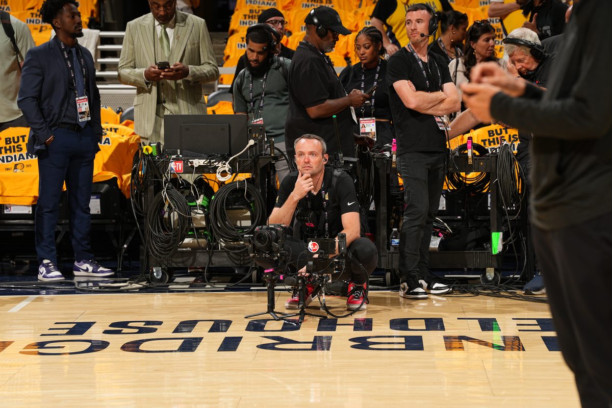 Matt Lingerfelt kneeling courtside with the RS 4 Pro in Indiana